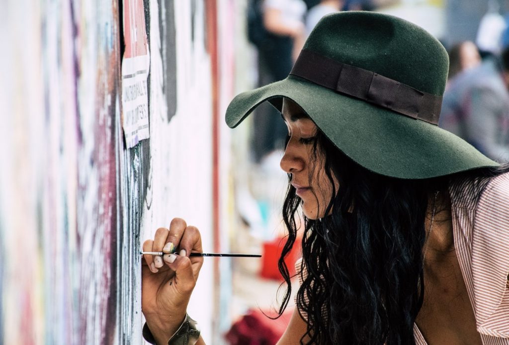 Girl painting on wall